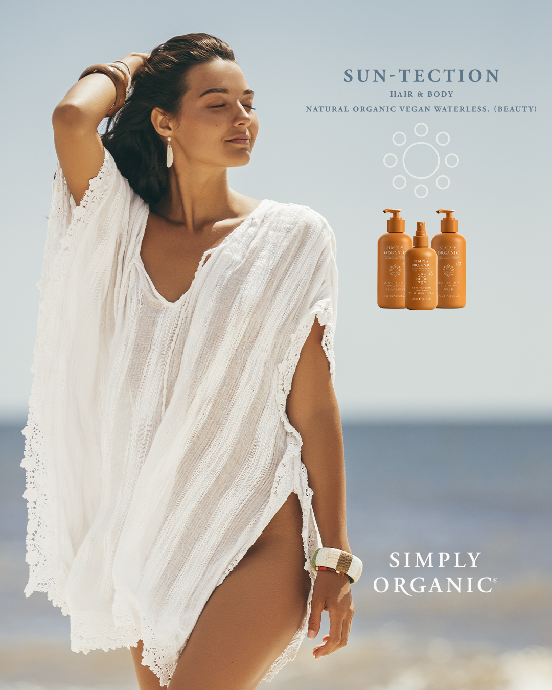 Modella in tunica bianca sulla spiaggia con Simply Organic SunTection Set